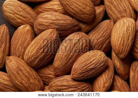 Close up of a pile of almonds as background.