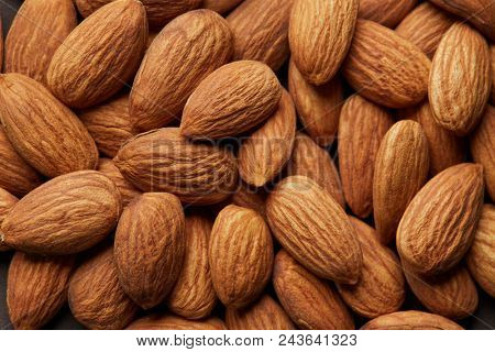 Pile of almonds close-up as background.