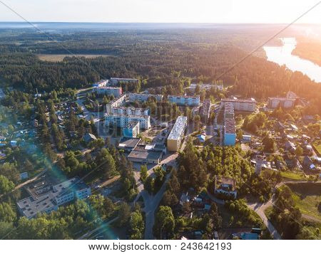 Flying over urban-type settlement Nikolskiy, Svir river and summer green forests of Leningrad region, Russia. 