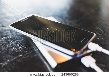 Bangkok, Thailand - May 24, 2018: Samsung Galaxy S7 Edge Smartphone Charging Power Via Powerbank Bat