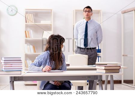Male lecturer giving lecture to female student