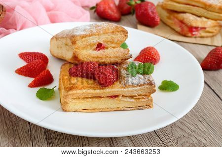 Sweet Tasty Puff Pastry Dessert On A Plate On A Wooden Background. Delicious Homemade Cookies With S