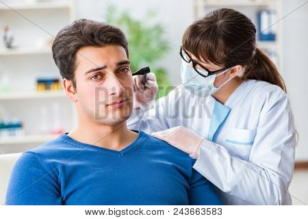 Doctor checking patients ear during medical examination