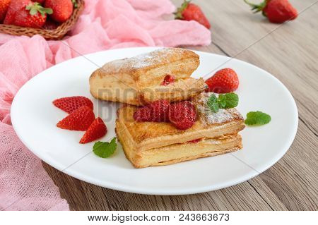 Sweet Tasty Puff Pastry Dessert On A Plate On A Wooden Background. Delicious Homemade Cookies With S