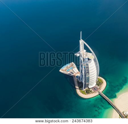 DUBAI, UAE - MARCH 2018: Aerial view of Burj Al Arab hotel in Dubai, one of the most luxury hotel in the world.