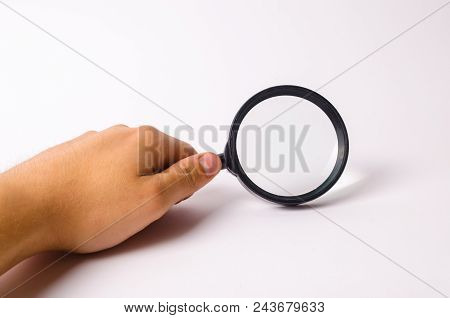 A Hand Is Holding A Magnifying Glass Against A White Background. Find Information And Things, Specia