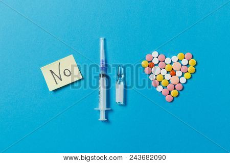 Medication White, Colorful Round Tablets In Form Of Heart Isolated On Blue Background. Pills Ampoule