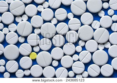 Yellow And White Tablets Scattered On A Blue Medical Table, Background, Texture