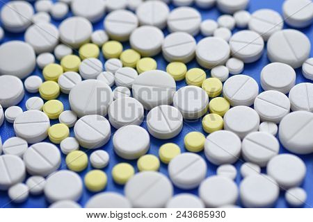 Round Tablets Arranged Abstract Isolated On Blue Color Background. Pills For Design. Concept Of Heal