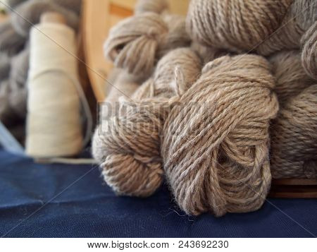 Skeins Of Natural Colored Handspun Sheep Wool Yarn In A Basket At An Agricultural Fiber Festival.