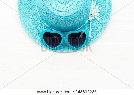 Beach Accessories Including Blue Sunglasses And Cyan Beach Hat On White Wooden Background For Summer