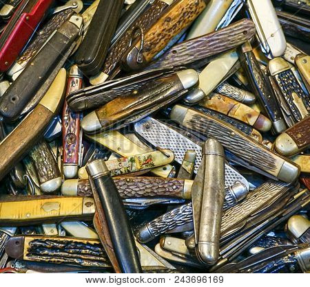 An Up Close View Of A Collection Of Old Vintage Pocket Knives
