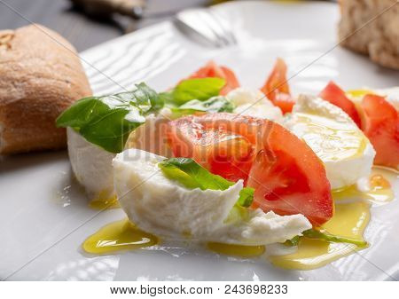 Caprese Salad With Tomatoes, Basil,  Mozzarella Balls, Made With White Ball Mozzarella Buffalo Itali
