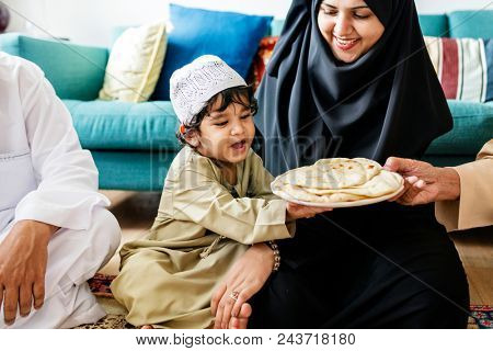 Muslim family having dinner on the floor