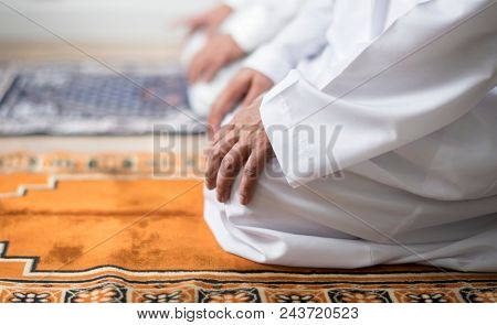 Muslim praying in Tashahhud posture