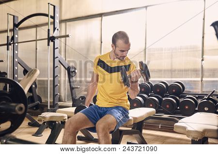 one young man, 25 years old, gym training on bike