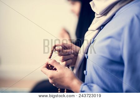 Muslim women using misbaha to keep track of counting in tasbih