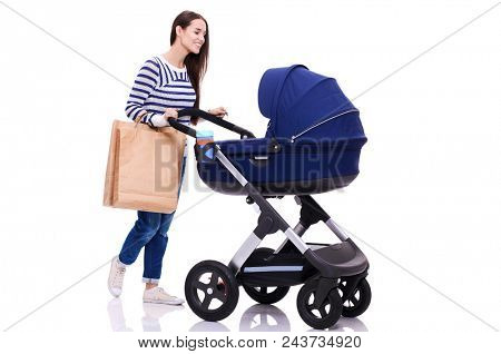 Full length portrait of a mother with a stroller, isolated on white background. Young mom