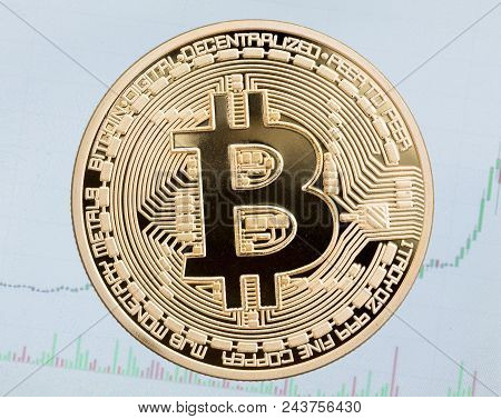 Golden Bitcoin On Blue Background. High Resolution Photo.