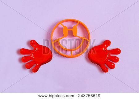 Forms For Baking In Shape Of Face With Smile And Hands On Lilac Background. Minimal Style. Creative 