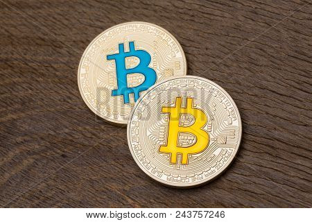 Golden Cryptocurrency Blue And Yellow Bitcoins On Wooden Backgound. High Resolution Photo.