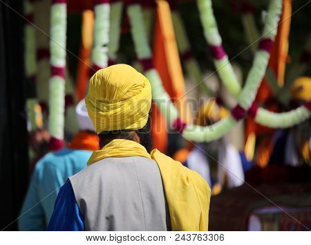 Sikh Man With Yellow Turban During The Religious Rite Called Nagar Kirtan