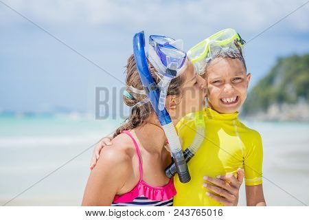 Portrait Of Brother And Sister In Scuba Masks Playing And Having Fun On The Beach During The Hot Sum