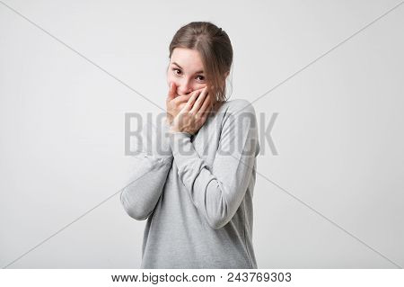 Lovely And Sensual Caucasian Female Being Shy, Holding Hands Near Chin And Smiling Seductively While