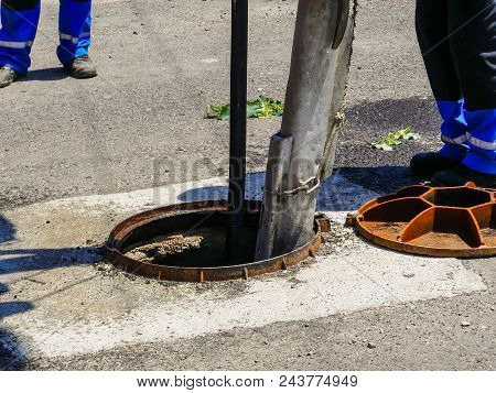 Workers Cleaning The Sewage At A Residentual House On A Bright Sunny Day.