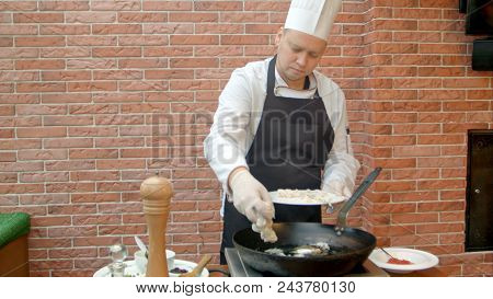 Chef Putting Fresh Seafood To A Pan. Professional Shot In