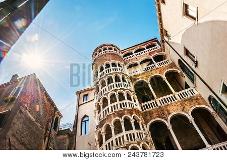 Palazzo Contarini Del Bovolo With Arch Spiral Staircase In Venice, Italy. Lens Flare Effect