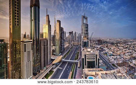 Dubai skyline during sunrise, Sheikh Zayed road traffic,United Arab Emirates.