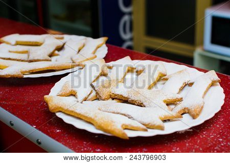 Many Cookies In The Form Of Arrows On A Plate.