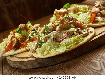 Loaded Chicken Tostadas, Topped With Cheese, Tomatoes, Guacamole, Olives And Jalapenos Are A Great W