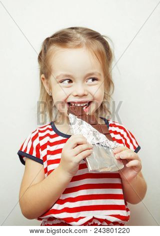 Lady Of Young Age, Dressed In Clothes With Pattern Of Red And White Stripes, In Process Of Eating Ch