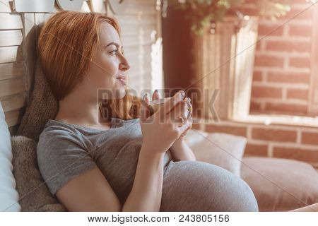 Pregnancy, Drinks, Rest, People And Expectation Concept - Happy Pregnant Woman With Cup Drinking Tea