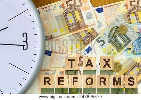 Words, Tax Reforms, Consisting Of Letters On Wooden Construction Cubes Against The Background Of Eur