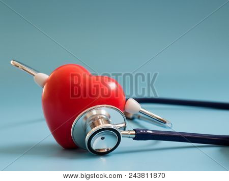 Red Heart Using Deep Blue Stethoscope On The Blue Background For Hear Their Own Heart. Concept Of Lo