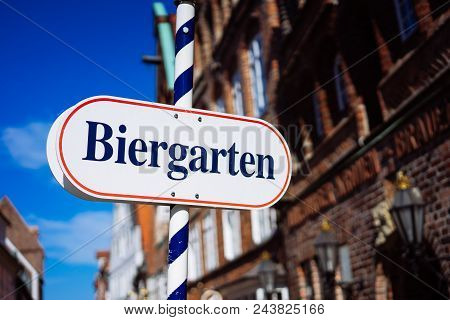 Beer Garden Sign. Opened Shield In German Biergarten On A Sunny Holiday. Old Traditional Buildung An