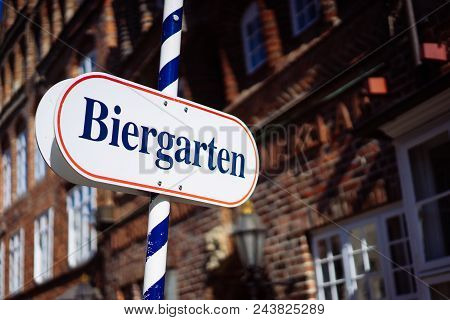 Beer Garden Sign. Opened Shield In German Biergarten On A Sunny Holiday. Old Traditional German Buil