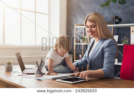 Happy Beautiful Business Mom Using Digital Tablet While Spending Time With Her Cute Baby. Business, 