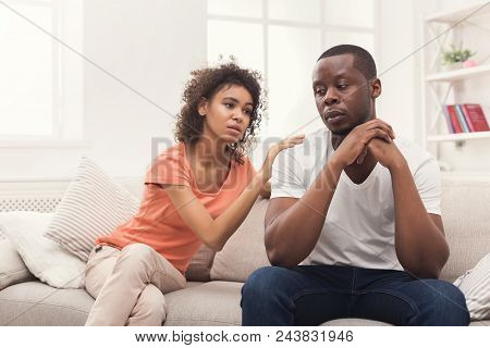 Young African-american Couple Making Peace After Quarreling At Home, Man Still Feeling Offended. Fam