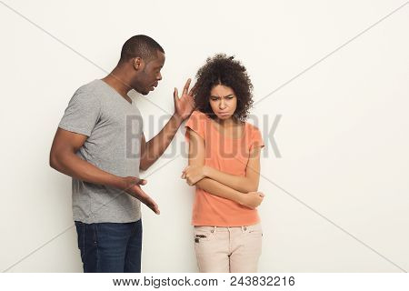 Black Couple Arguing. Angry African-american Men Shouting At His Girlfriend At White Studio Backgrou