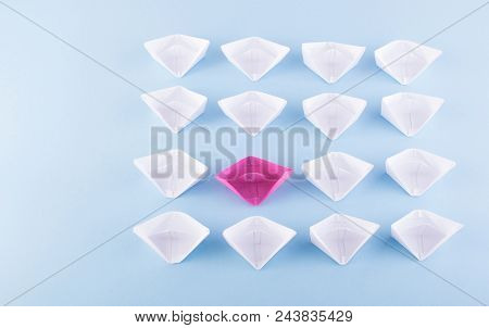 One Unique Pink Paper Boat Among Many Ones. Different Paper Ships As Think Different And Creativity 