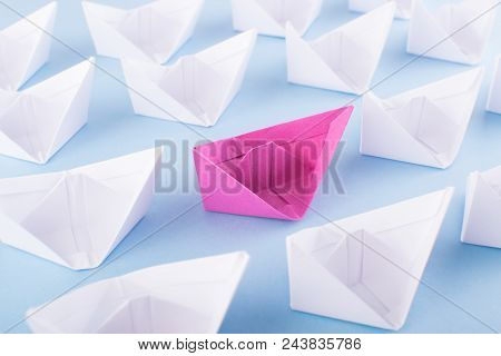 One Unique Pink Paper Boat Among Many Ones. Different Paper Ships As Think Different And Creativity 