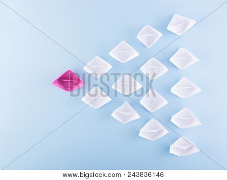 One Unique Pink Paper Boat Among Many Ones. Different Paper Ships As Individuality And Leadership Co