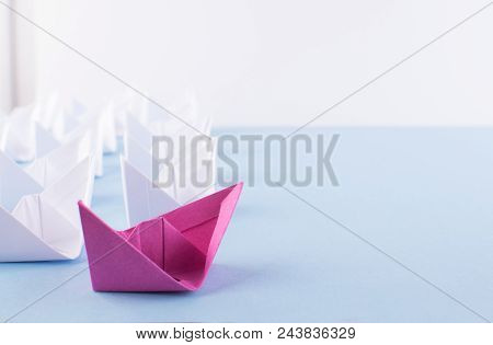 One Unique Pink Paper Boat Among Many Ones. Different Paper Ships As Individuality And Leadership Co