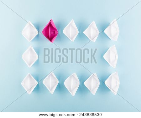 One Unique Pink Paper Boat Among Many Ones. Different Paper Ships As Think Different And Creativity 
