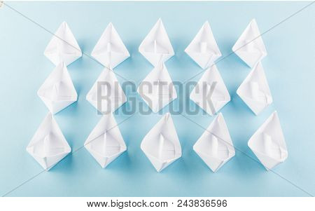 White Paper Boats Or Paper Ships Origami On Blue Background