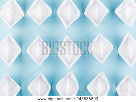 White Paper Boats Or Paper Ships Origami On Blue Background Top View